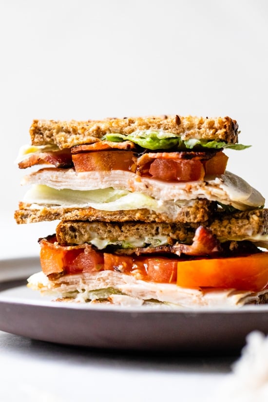 A classic Turkey Club sandwich made healthy, piled high with turkey breast, bacon, lettuce, and tomato on whole grain bread, the perfect easy lunch.
