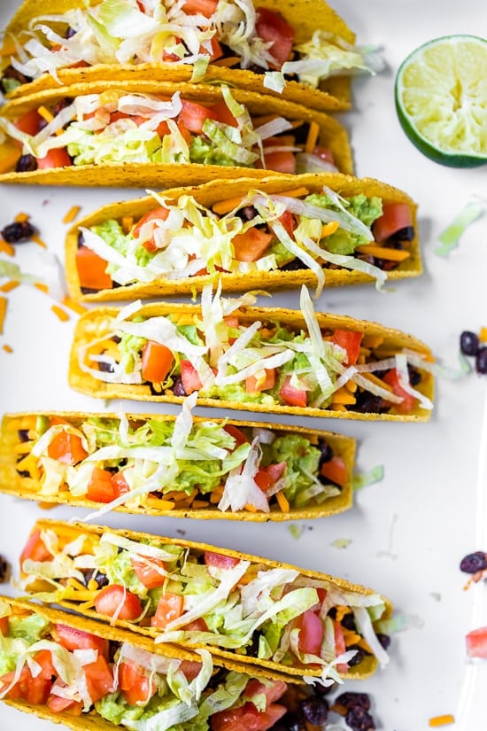 Vegetarian Black Bean Tacos served in crunchy corn shells and filled with classic taco toppings are so good that you definitely won’t miss the meat.