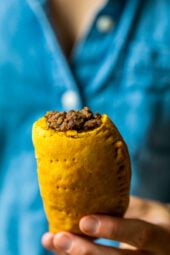 Girl holding a Jamaican Beef Patty