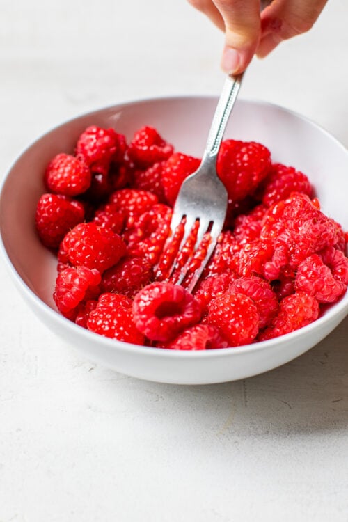 raspberries mashed in a bowl