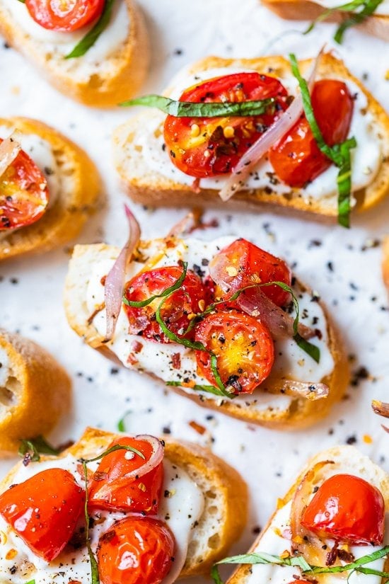 Whipped Ricotta Toast with Roasted Tomatoes on a white background