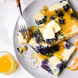 Lemon Blueberry Buttermilk Sheet Pan Pancakes on a plate with syrup.