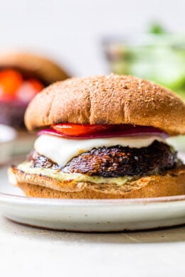 These grilled Portobello Mushroom Burgers topped with mozzarella, red peppers, and pesto mayo, are delicious and an excellent vegetarian burger option.
