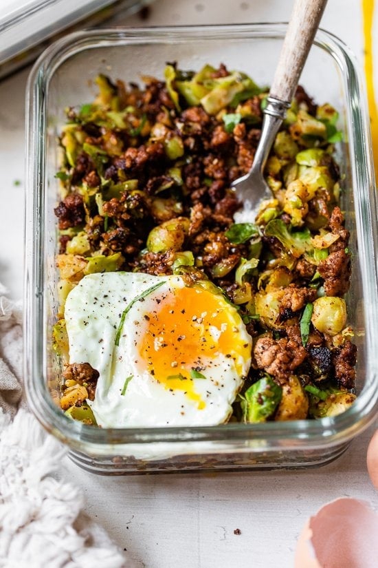 Spicy Pork Brussels Bowls in glass meal prep container