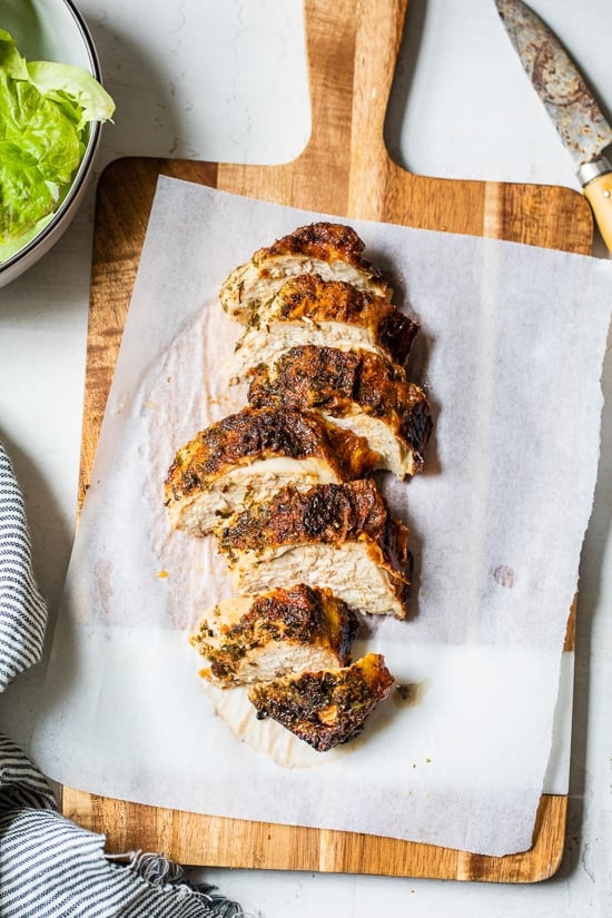 sliced chicken breast on cutting board