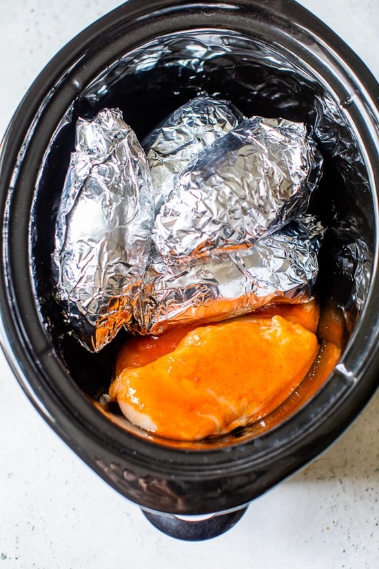 Slow cooker with sweet potatoes and chicken.