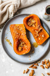Honeynut squash on a plate with pecans.