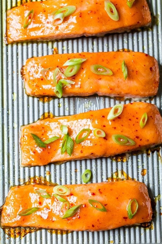 Sweet and Spicy Baked Salmon "width =" 550 "height =" 825 "data-pin-description =" Sweet and Spicy Baked Salmon is super easy and is baked on a sheet pan with a simple glaze made from just three ingredients: sweet red chili sauce , Sriracha and fresh ginger. #salmon #easysalmon #glazedsalmon "srcset =" https://www.skinnytaste.com/wp-content/uploads/2020/10/Sweet-and-Spicy-Sheet-Pan-Salmon-4.jpg 550w, https: / /www.skinnytaste.com/wp-content/uploads/2020/10/Sweet-and-Spicy-Sheet-Pan-Salmon-4-500x750.jpg 500w, https://www.skinnytaste.com/wp-content/ Uploads / 2020/10 / Sweet-and-Spicy-Sheet-Pan-Salmon-4-170x255.jpg 170w, https://www.skinnytaste.com/wp-content/uploads/2020/10/Sweet-and-Spicy -Sheet-Pan-Salmon-4-260x390.jpg 260w, https://www.skinnytaste.com/wp-content/uploads/2020/10/Sweet-and-Spicy-Sheet-Pan-Salmon-4-150x225. jpg 150w "data sizes =" (maximum width: 550px) 100vw, 550px "/><img loading=
