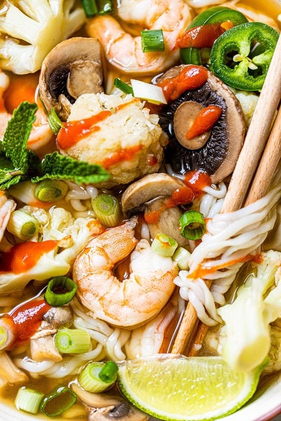 Shrimp veggies and noodle soup with chopsticks