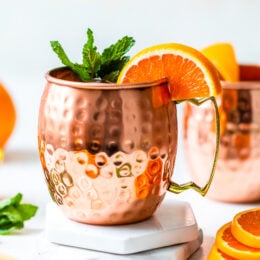orange moscow mule in copper mugs