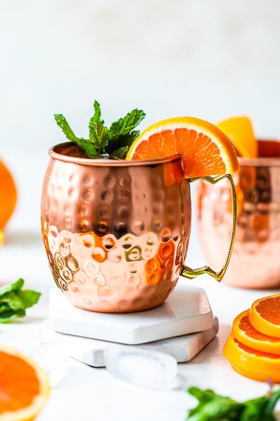 orange moscow mule in copper mugs