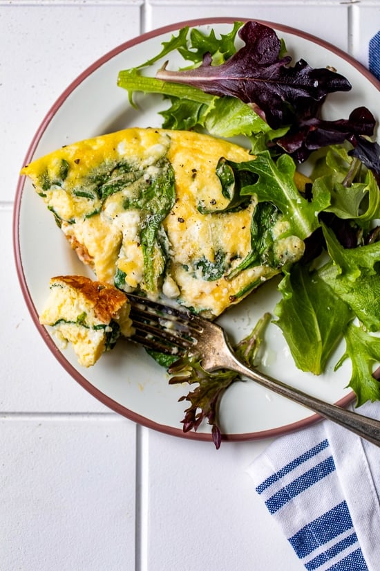 frittata on a plate with salad.