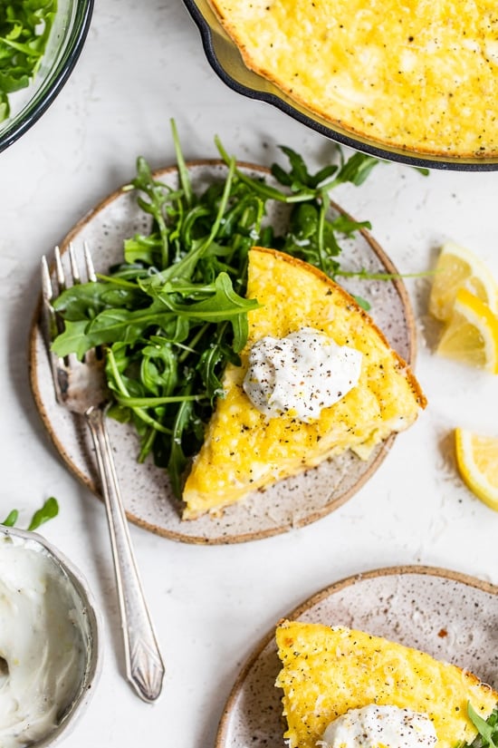 This creamy and delicious Cacio e Pepe Frittata is an interesting variation of the classic pasta dish.  High-protein breakfast, lunch or dinner made with grilled cauliflower, Greek yogurt, eggs, and Parmesan is served with some lemon yogurt and arugula salad.