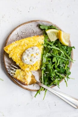 This creamy and delicious Cacio e Pepe Frittata is a fun twist on the Italian classic pasta dish. A protein- packed breakfast, lunch or dinner made with roasted cauliflower, Greek yogurt, eggs, and Parmesan served with a dollop of lemony yogurt and arugula salad.