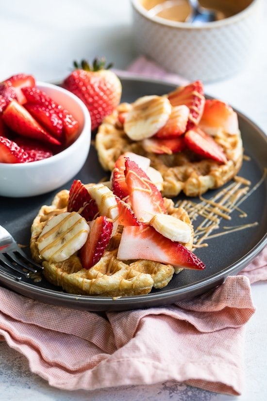 Oat waffle with strawberries, peanut butter and banana.