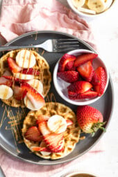 Waffles with strawberries, peanut butter and bananas.