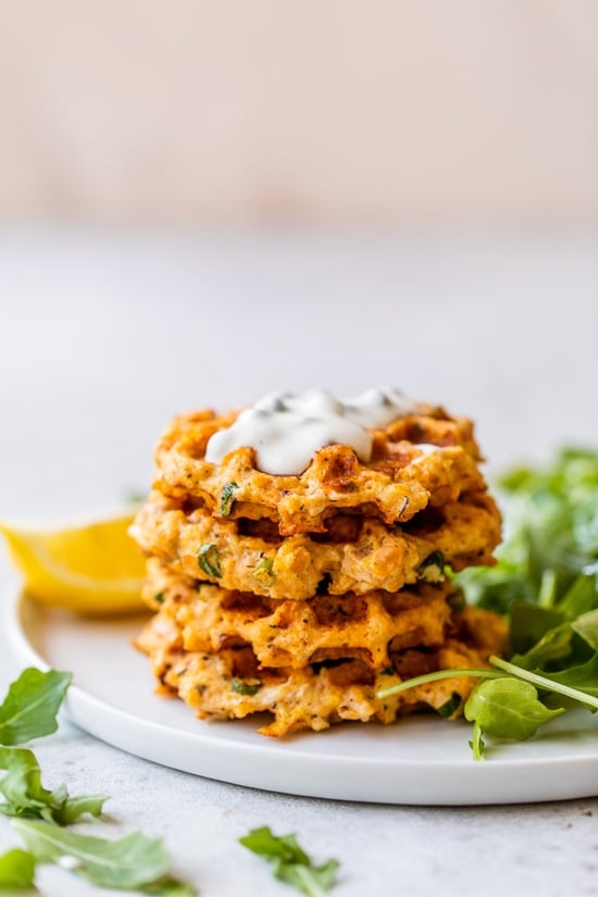 Salmon cakes stacked on a plate