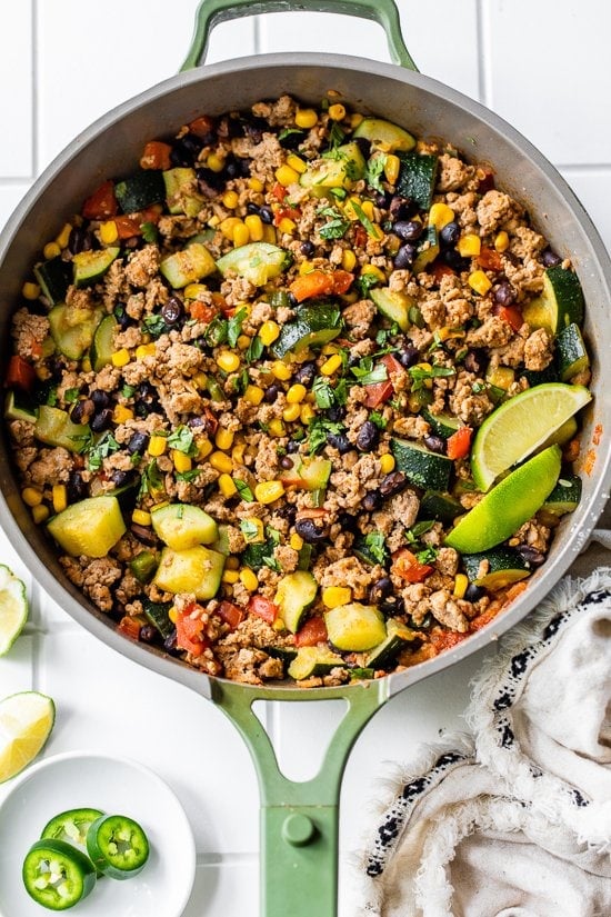 Ground Turkey with Zucchini, Corn, Black Beans and Tomatoes in a skillet.