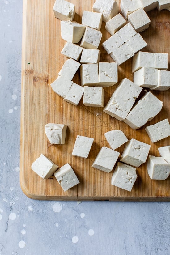 Tofu cubes on cutting board
