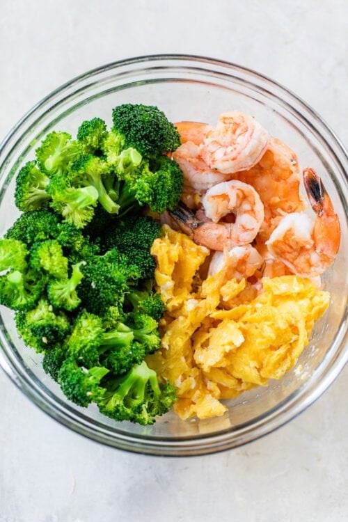 Eggs broccoli and shrimp in a bowl.