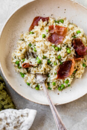 A bowl of risotto with peas and prosciutto
