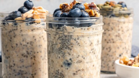 3 jars of overnight oats topped with blueberries and walnuts