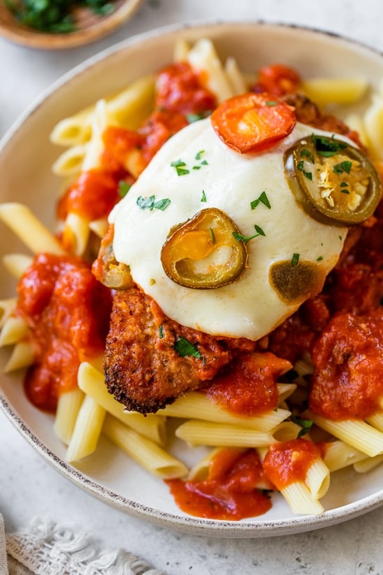 Chicken parmesan cheese and hot cherry peppers served with pasta