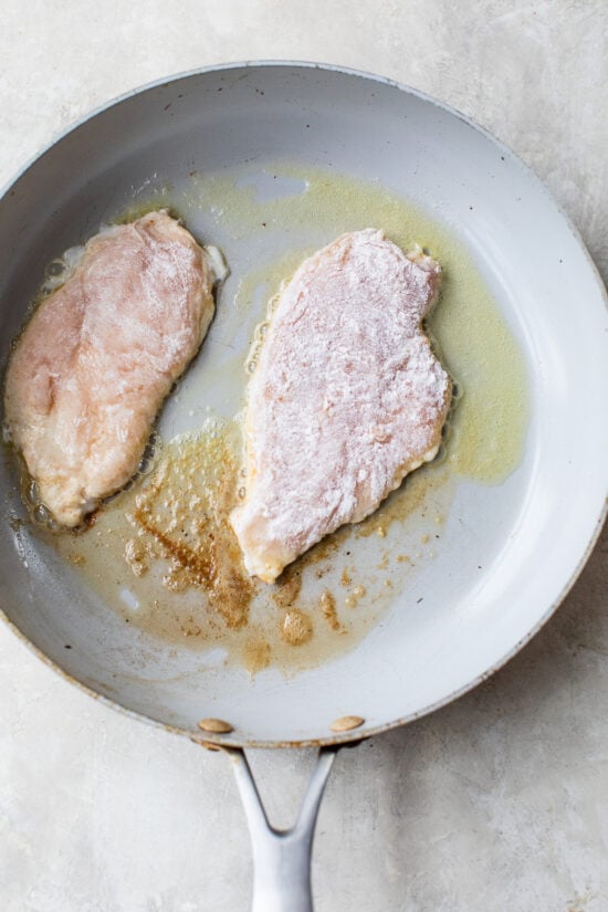 chicken breast dredged in flour and cooked in a pan