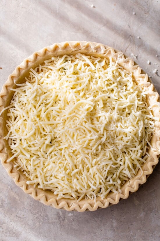 pie crust topped with shredded mozzarella cheese