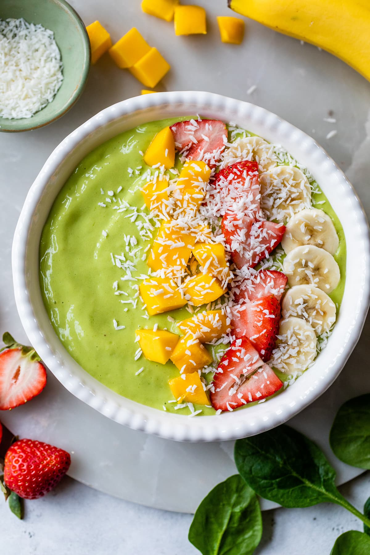 mango and strawberry green smoothie bowl