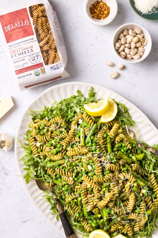 pasta with arugula, peas and asparagus on a platter