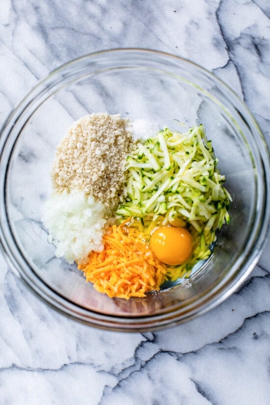 zucchini, cheese, egg and panko in a bowl