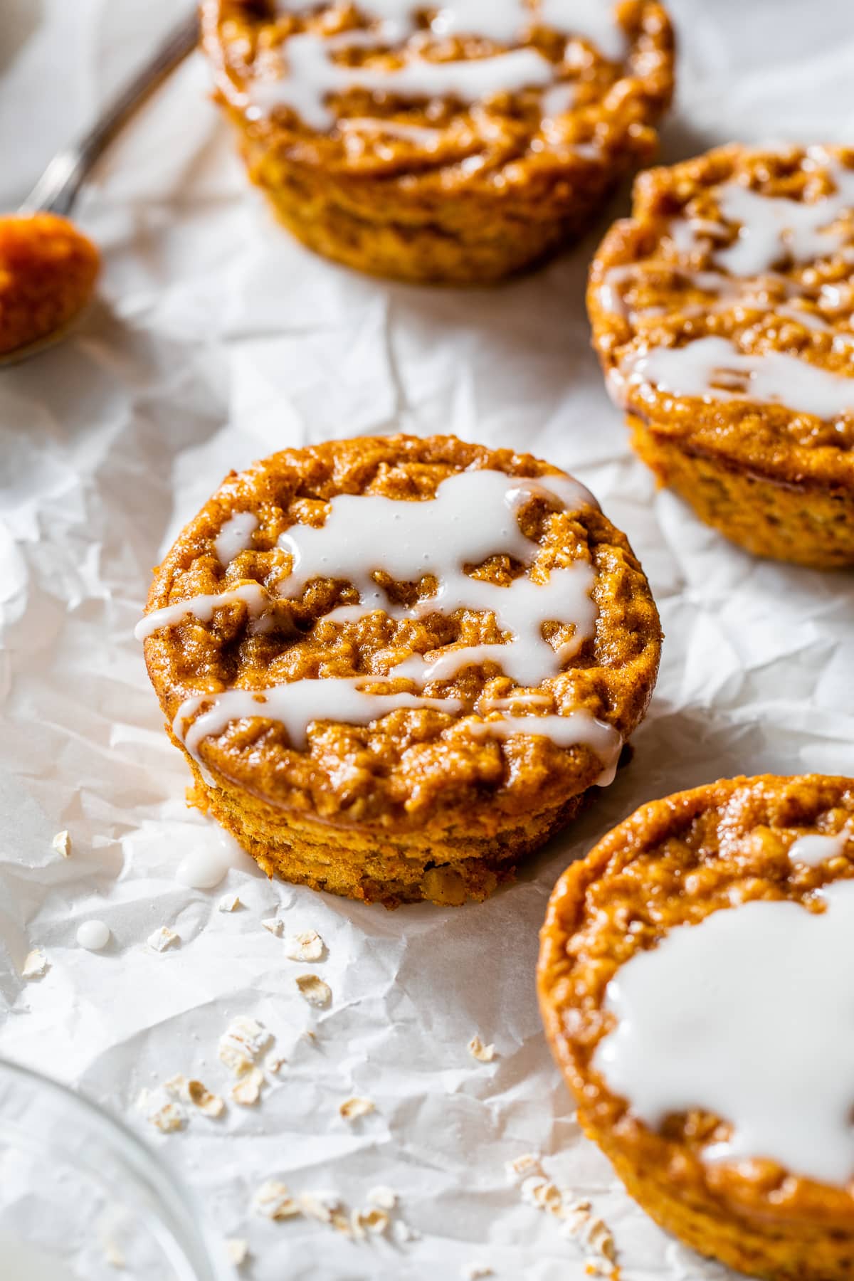 Pumpkin Baked Oatmeal Cups drizzled with vanilla glaze