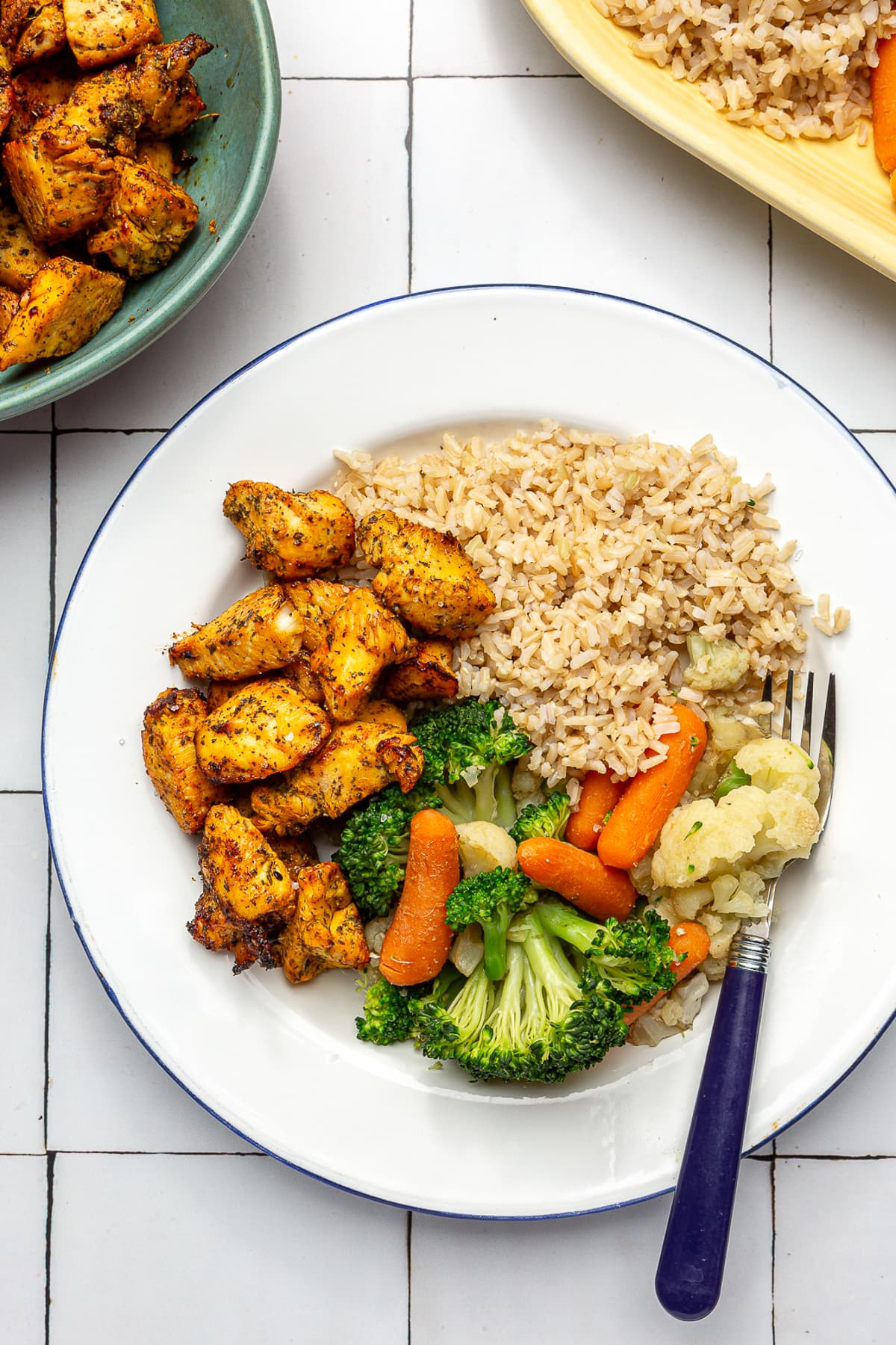 Air Fryer Chicken Breast bites with rice and veggies.