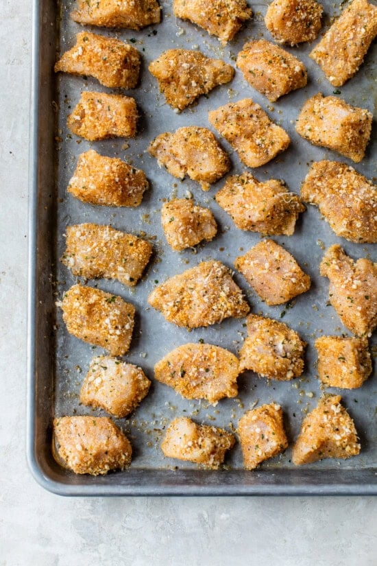 Place Baked Chicken Nuggets on a sheet pan and bake.