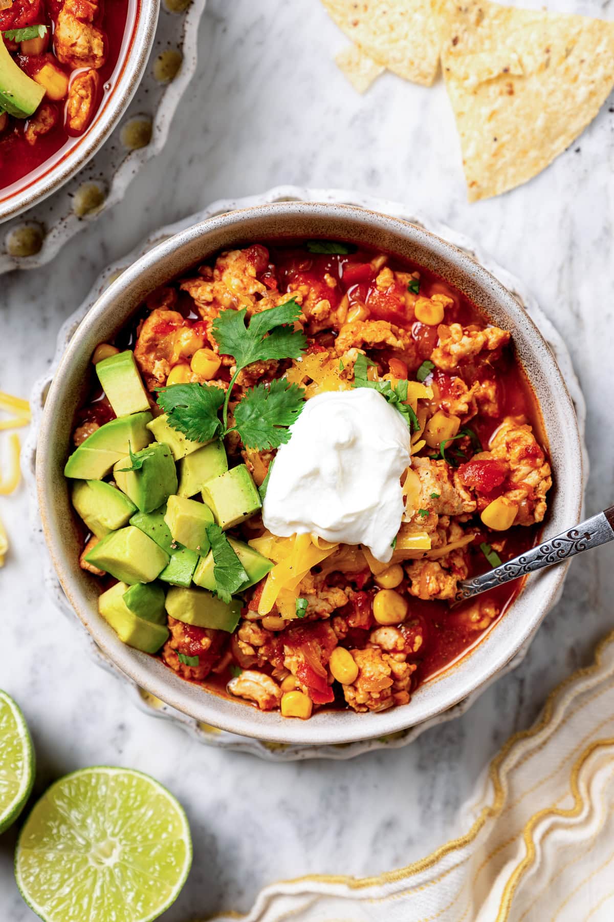 This crock pot turkey chili recipe is easy to make and family-friendly, with ground turkey, corn, bell pepper, tomatoes, and mild spices. Crockpot Turkey Chili