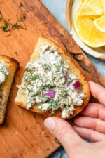 Sardine Salad on toast with a hand