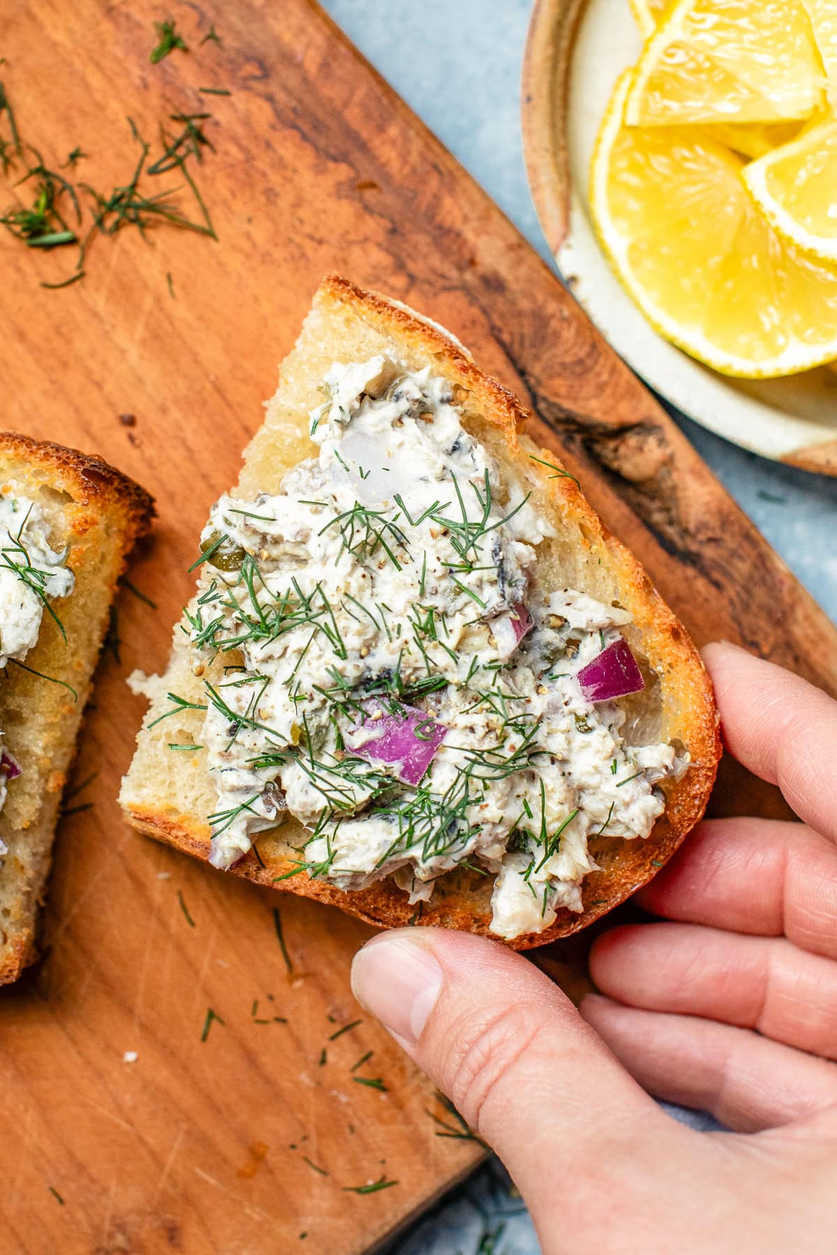 Sardine Salad on toast with a hand
