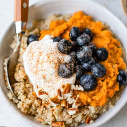 Healthy breakfast bowl with sweet potatoes, blueberries, and quinoa.